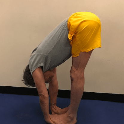 Man doing forward bend yoga pose