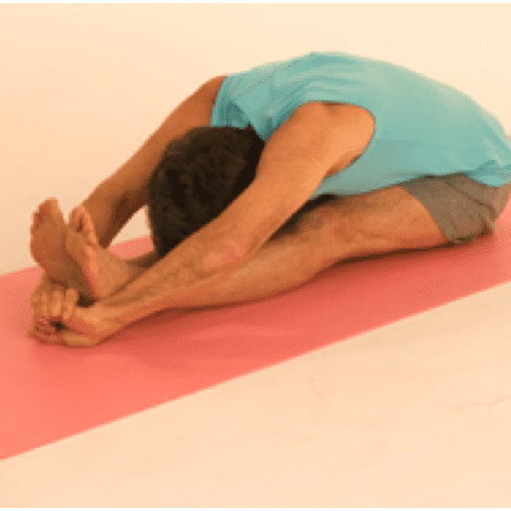 Man doing seated forward bend yoga pose