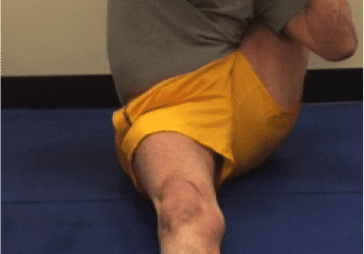 Individual stretching on a blue mat