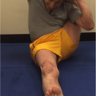 Individual stretching on a blue mat