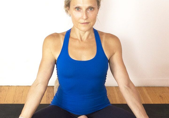 Person meditating on yoga mat