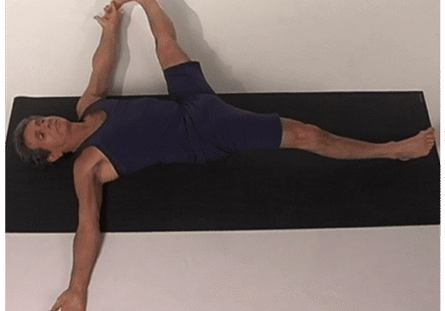 Individual practicing yoga exercise on floor