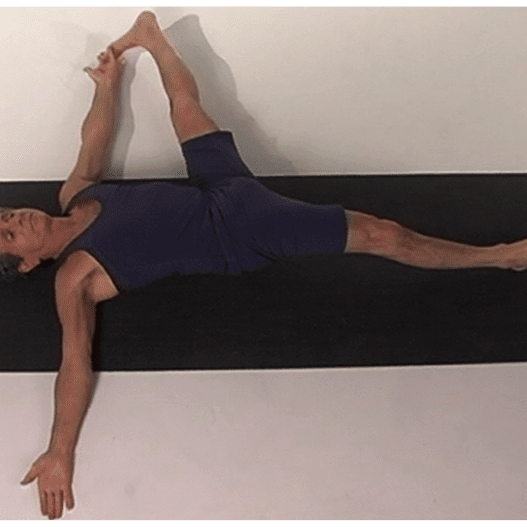 Individual practicing yoga exercise on floor