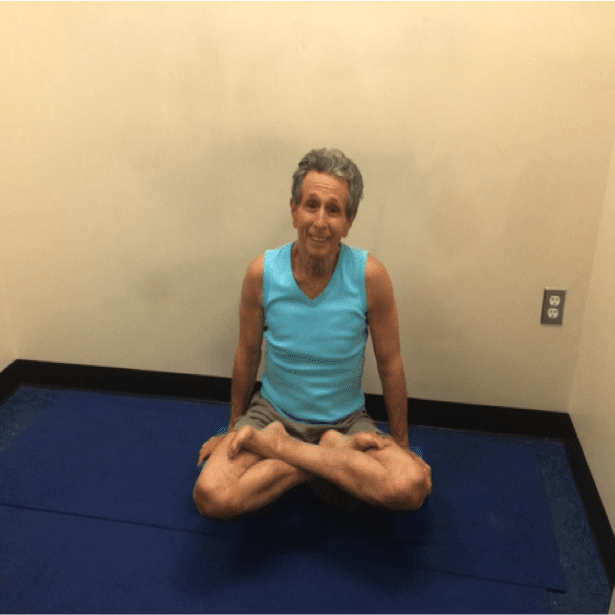 Person meditating in turquoise tank top