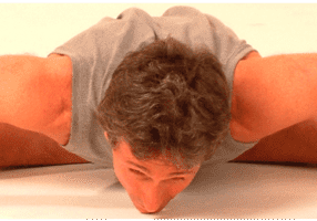 Person practicing flexibility exercise on floor