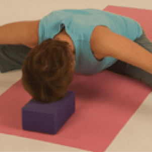 Yoga pose with block on mat