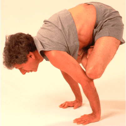 Man practicing advanced yoga pose