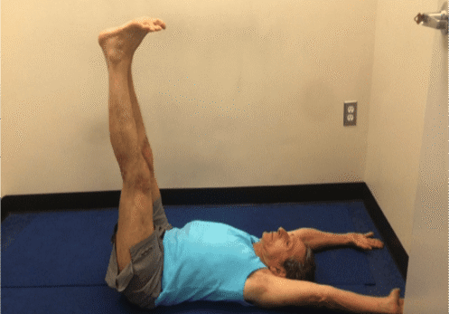 Person doing leg exercise indoors