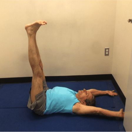 Person doing leg exercise indoors
