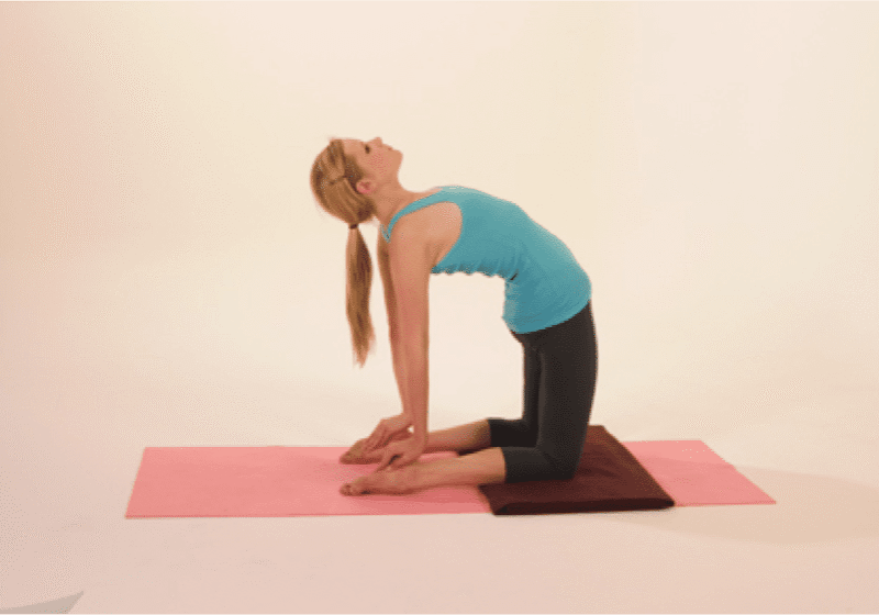 Woman practicing yoga camel pose