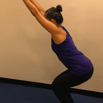 Woman practicing yoga chair pose