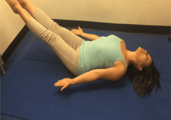 Woman doing a yoga pose on mat.