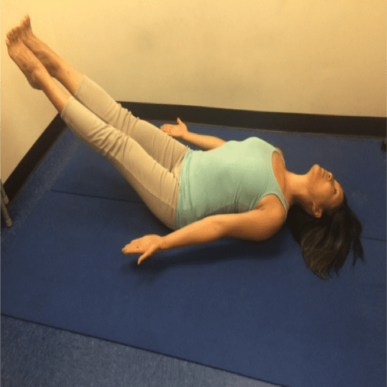 Woman doing a yoga pose on mat.