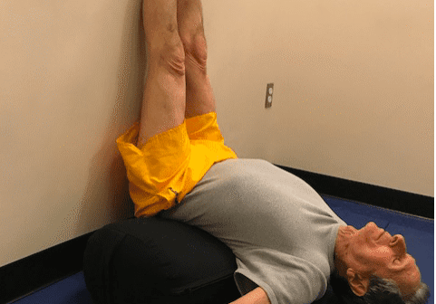 Man doing yoga legs-up-the-wall pose