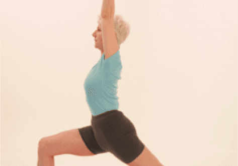 Woman practicing Warrior I yoga pose