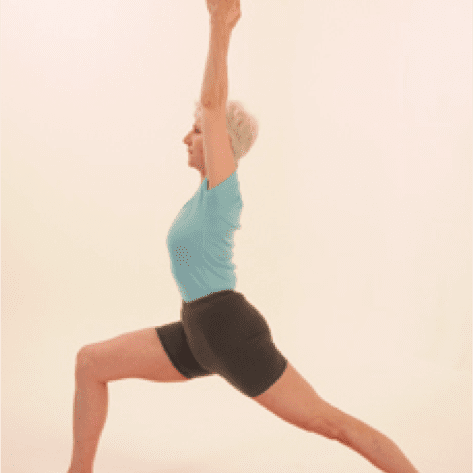 Woman practicing Warrior I yoga pose