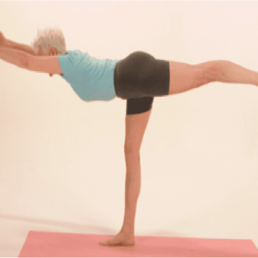 Woman practicing yoga on a pink mat.