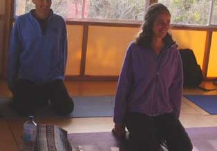 Two people practicing yoga indoors