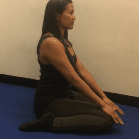 Woman practicing seated yoga pose