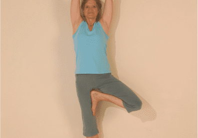 Yoga pose with raised arms and leg