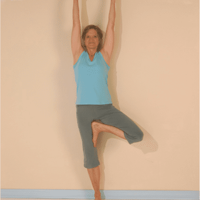 Yoga pose with raised arms and leg